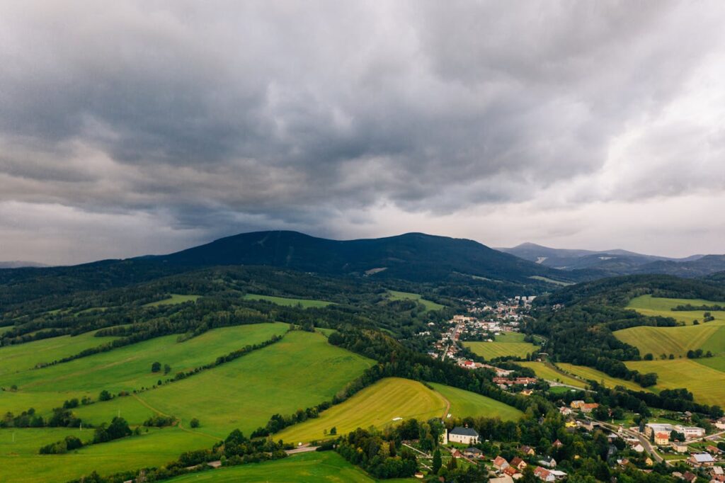 A stunning aerial view of lush fields and mountains in Pec pod Sněžkou, Czechia.